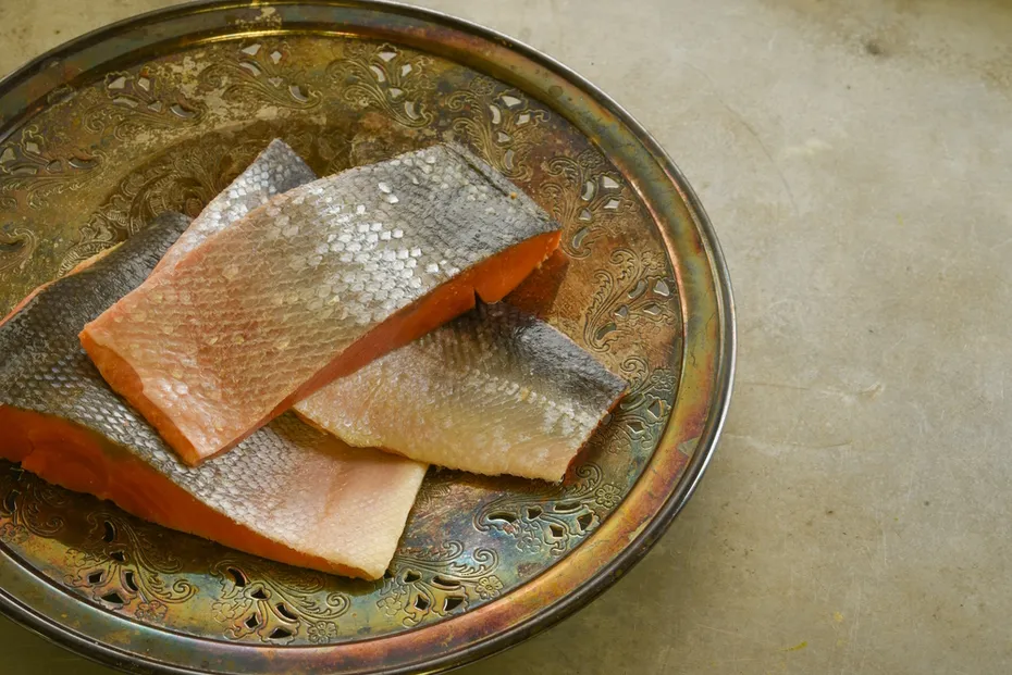 Wild-sockeye-salmon-fillets-on-an-ornate-vintage-silver-plate