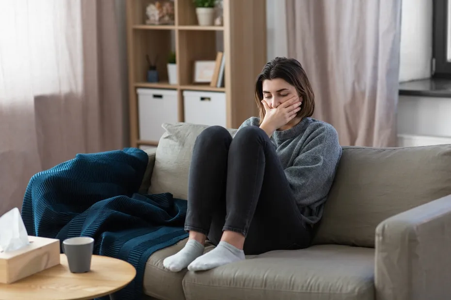 Scared woman sitting on a couch