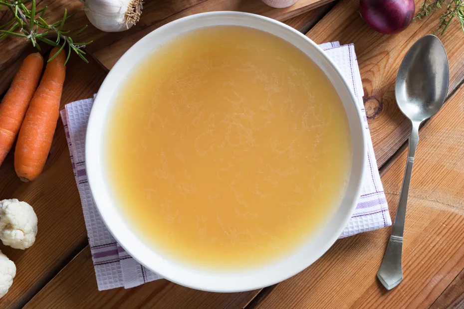 chicken broth on wooden table