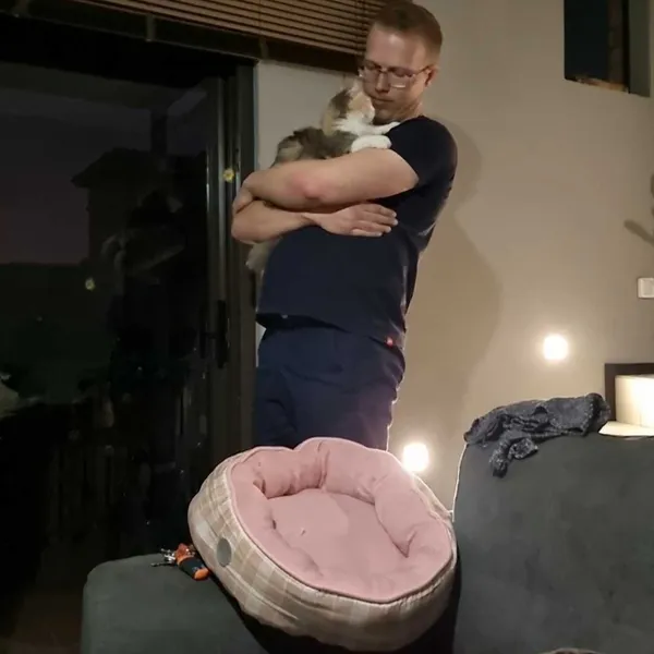 Working her magic on my fiance + her cute cat bed