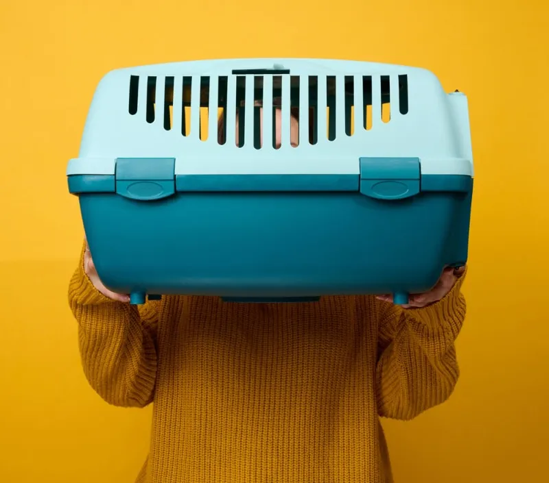 woman holding a pet carrier