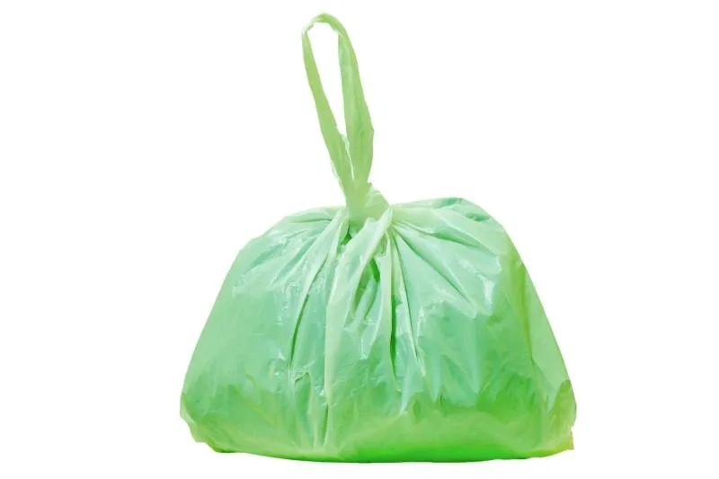 Green plastic bag isolated on white background