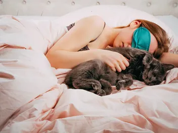 Why Does My Cat Sleep Next to Me? 5 Vet-Reviewed Reasons for This Behavior
