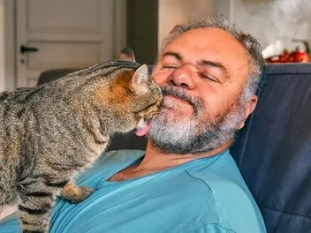 Why Do Cats Rub Their Faces on You? 3 Vet-Reviewed Reasons