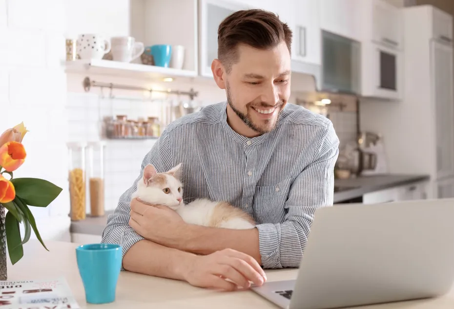 man-with-cat-using-laptop