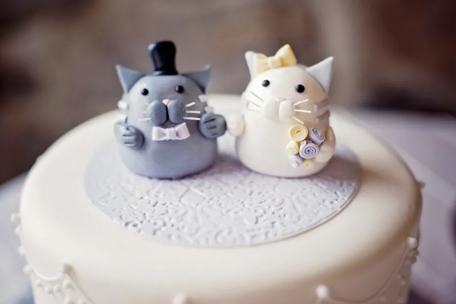 close up of wedding cake topper fondant cats white and grey bride and groom