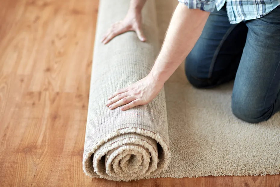 close up of male hands rolling carpet