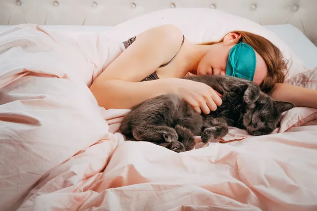 Why Does My Cat Sleep Next to Me? 5 Vet-Reviewed Reasons for This Behavior