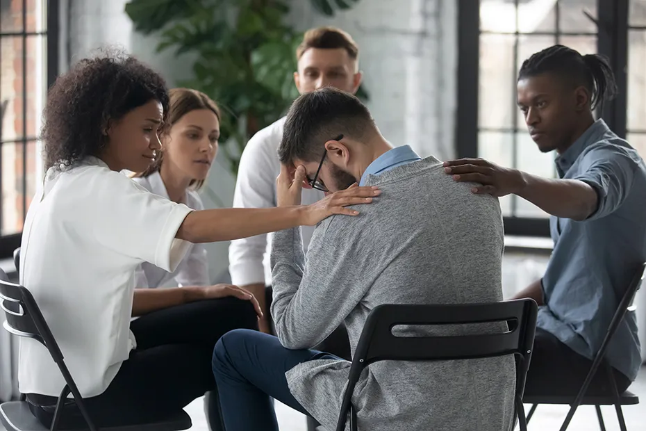 support group comforting a young man