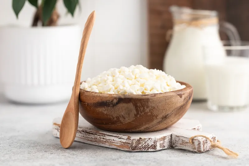 natural cottage cheese in a wooden bowl