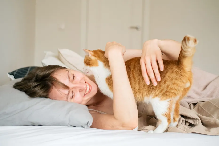 Woman hugging her cat at the morning