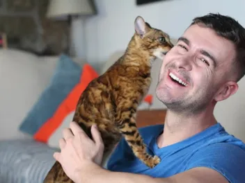 Why Does My Cat Lick My Ear? 3 Vet-Reviewed Possibilities