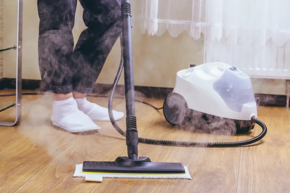 woman cleaning the floor with steam cleaner
